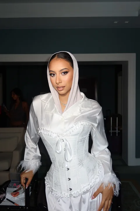 Modern bride in a draped satin hood — luminous bridal makeup with sculpted skin